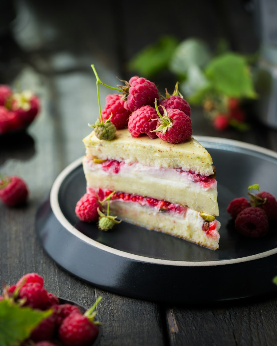 A slice of raspberry layer cake on a ceramic plate