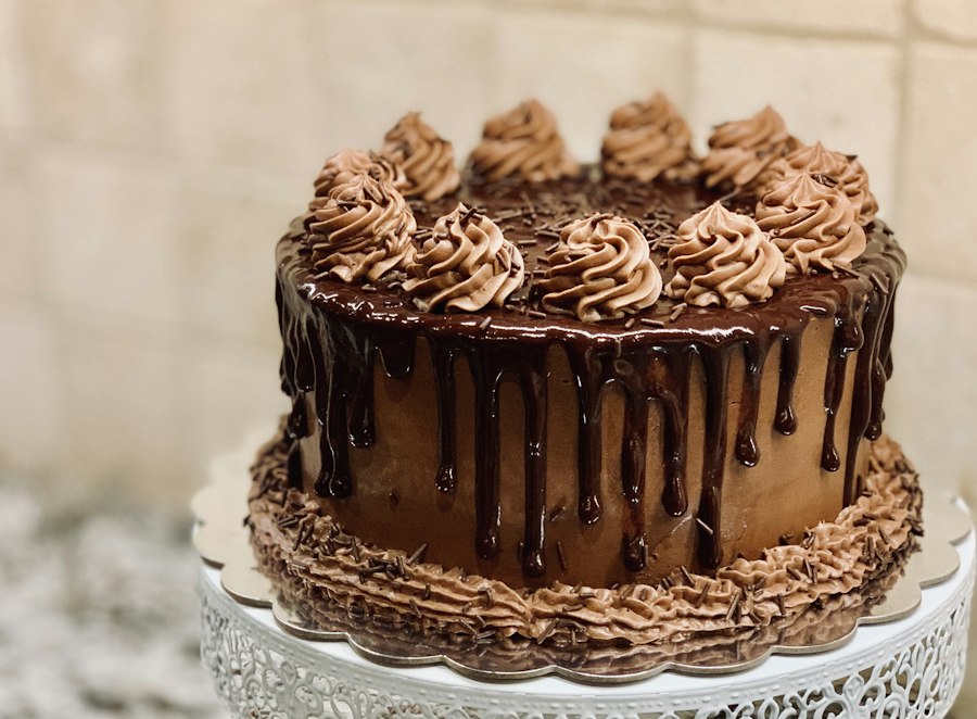 Chocolate celebration cake with piped frosting and a glossy chocolate drip